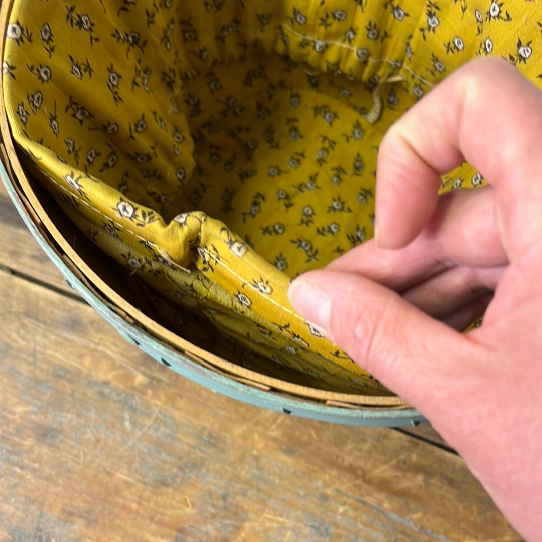 Small blue/green fruit basket with yellow floral fabric liner