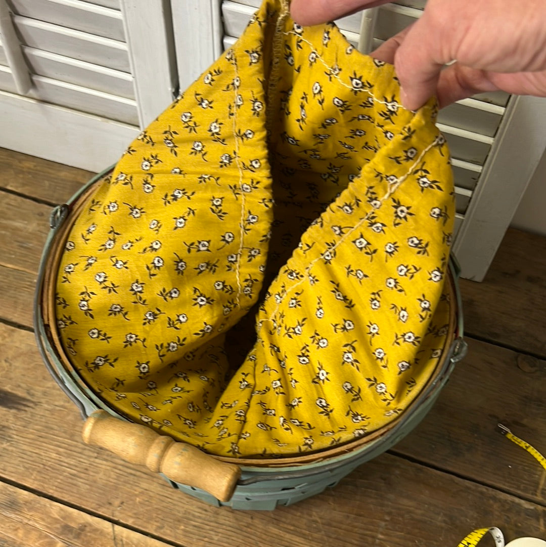 Small blue/green fruit basket with yellow floral fabric liner